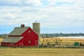 Red Barn with Cows and Encroaching Suburban Homes and Condominiums in the Background Royalty Free Stock Photo