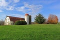 Red Barn and Dairy Silo on Green Meadow