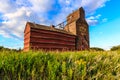 A red barn with a grain silo in the background Royalty Free Stock Photo
