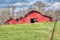 A red barn on a hilltop on a large farm. Royalty Free Stock Photo