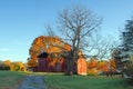 A red barn in intense autumn sun Royalty Free Stock Photo