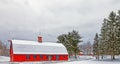 red barn with many windows in Winter white snow after snowstorm Royalty Free Stock Photo