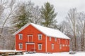 red barn with many windows in Winter white snow after snowstorm Royalty Free Stock Photo