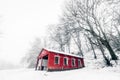 Red barn in a misty winter landscape Royalty Free Stock Photo