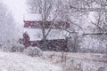 Red barn in a snow stoarm Royalty Free Stock Photo