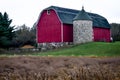 Red Barn with Stone Silo and Cone Top Royalty Free Stock Photo