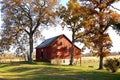 Red barn and tall fall trees Royalty Free Stock Photo