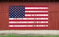 red barn wall american flag painted faded worn weathered farmland heartland america symbol patriotism building Royalty Free Stock Photo