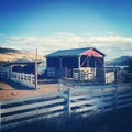 Red barn and white fence on hillside Royalty Free Stock Photo