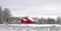 red barn and white silo at edge of field covered in fresh fallen Winter white snow Royalty Free Stock Photo