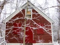 Red Barn in the winter in a forest; peaceful Royalty Free Stock Photo