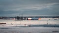 Red barns in afternoon winter sunlight on snow covered farmlands in SkÃÂ¥ne Sweden