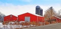 Red barns and silos in snow under blue sky Royalty Free Stock Photo