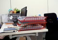 Red basket of documents on the desk