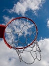 New Basketball hoop shot from below with clouds against blue sky Royalty Free Stock Photo