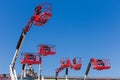 Red baskets on the booms of articulated boom lifts Royalty Free Stock Photo