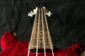 Red bass guitar with four strings on dark background Royalty Free Stock Photo