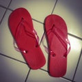 Red bath flip flops on white tiles Royalty Free Stock Photo