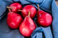 Red battler pears or red pears on a blue cloth. Organic and natural products. Healthy food