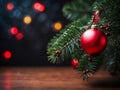 red bauble on christmas tree branch and colorful festive lights background with copy space