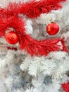 Red baubles with golden ornament on pine tree brenches