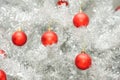 Red baubles on silver artificial christmas tree Royalty Free Stock Photo