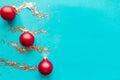 Red baubles and silver tinsel stripes on bright blue background. Royalty Free Stock Photo