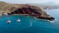 Red beach with catamarans in Santorini, Greece