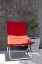 Red beach chair in contrast of color and light Royalty Free Stock Photo