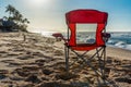 A red beach chair facing the sunset on Sunset Beach, Hawaii Royalty Free Stock Photo