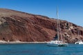 Red beach in Santorini view of the sea with katamaran