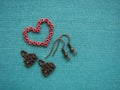 Red beads in form of heart, making earrings, handmade jewelry Royalty Free Stock Photo