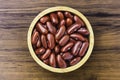 red beans or kidney bean in wooden bowl isolated on wood table background. Royalty Free Stock Photo