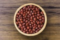 Red small Azuki beans  Adzuki or japanese red bean  in wooden bowl isolated on wood table Royalty Free Stock Photo