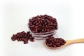 Red bean cereal in glass bowl and wooden spoon laid on white background Royalty Free Stock Photo