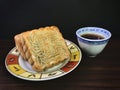 Red bean moon cake served with tea on wooden background . Royalty Free Stock Photo