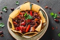 Red bean with nachos or pita chips, pepper and greens on plate over dark background. Mexican snack, Vegetarian food Royalty Free Stock Photo