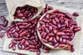 Red bean in wooden bowl on sack background / Grains red kidney beans Royalty Free Stock Photo