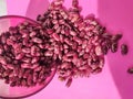Red beans beautifully laid out on a pink background
