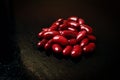 Red beans on a black background with drops of water Royalty Free Stock Photo