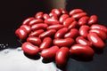 Red beans on a black mirror background close-up Royalty Free Stock Photo