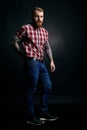 Red bearded man with tattoes studio portrait on dark background