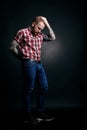 Red bearded man with tattoes studio portrait on dark background