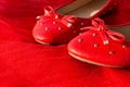 Red beautiful women`s shoes on bright fabric. Still life of a fashionable woman. Red ballet shoes on red. Copy space, women`s sh Royalty Free Stock Photo