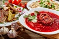 Red beet vegetable soup borscht on wooden background. Ukrainian and russian national food. Close-up. Royalty Free Stock Photo