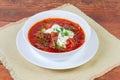 Red beetroot Ukrainian borscht in white bowl on rustic table Royalty Free Stock Photo