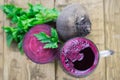 Red beets and beet juice in a glass mug on a rustic wooden table. Royalty Free Stock Photo