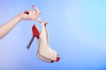 Red beige female shoes high heels in hands of woman on violet Royalty Free Stock Photo