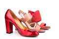 Red, beige and orange female shoes and sandals with high heels for sale side view on white background close up