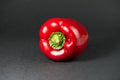 Red bell pepper on black background.